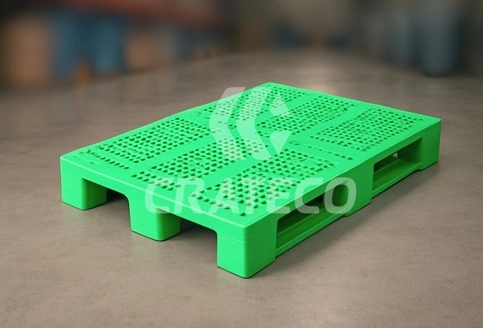 Close-up of plastic pallet showing lightweight build, forklift entry points, and surface design