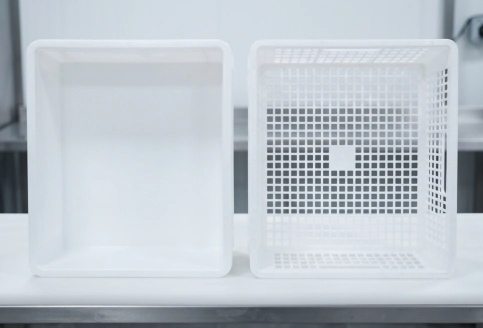 Close-up of ventilated crate walls showing airflow slots and hygienic smooth interior.
